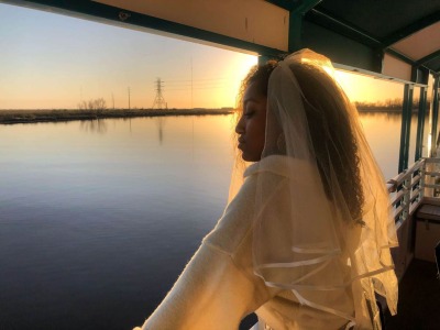 a woman standing in front of water