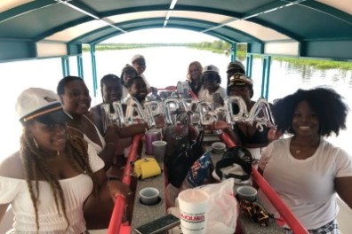 a group of people standing around a table