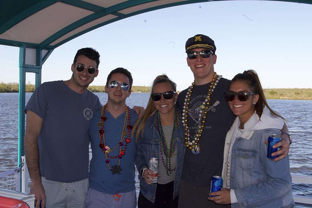 a man standing in front of a group of people posing for the camera
