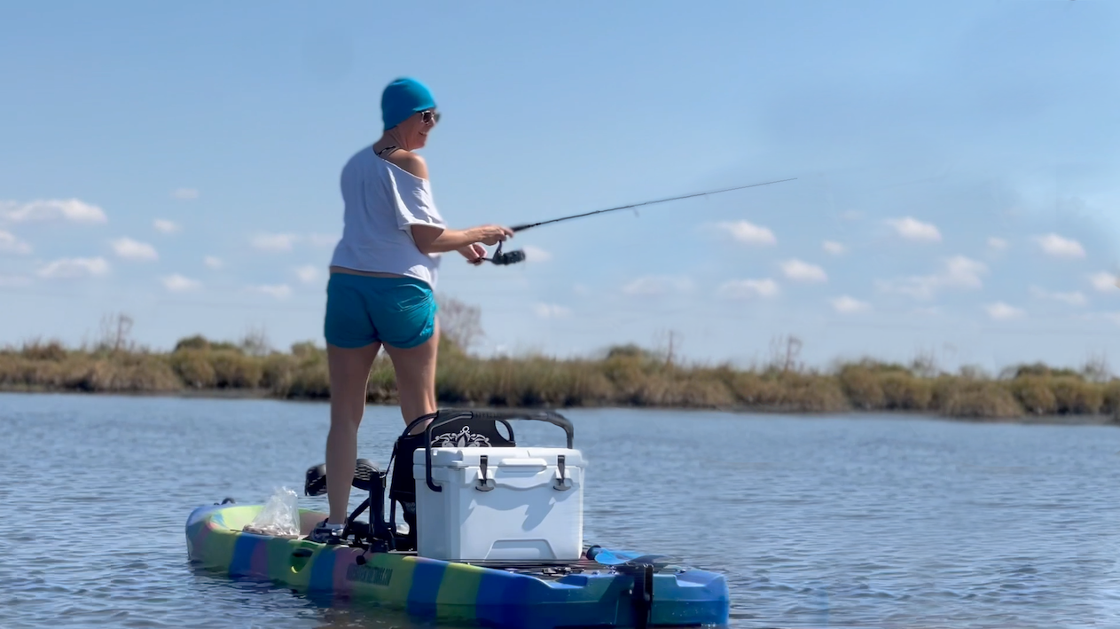 a person riding on the back of a boat in the water