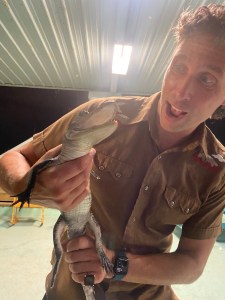 a man smiling with his hand on his head