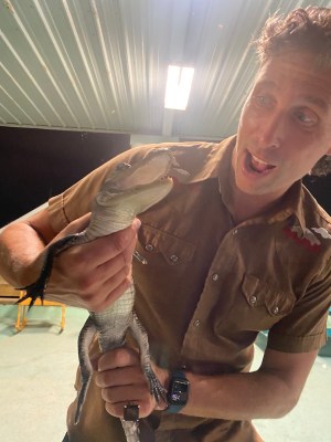 a man smiling with his hand on his head